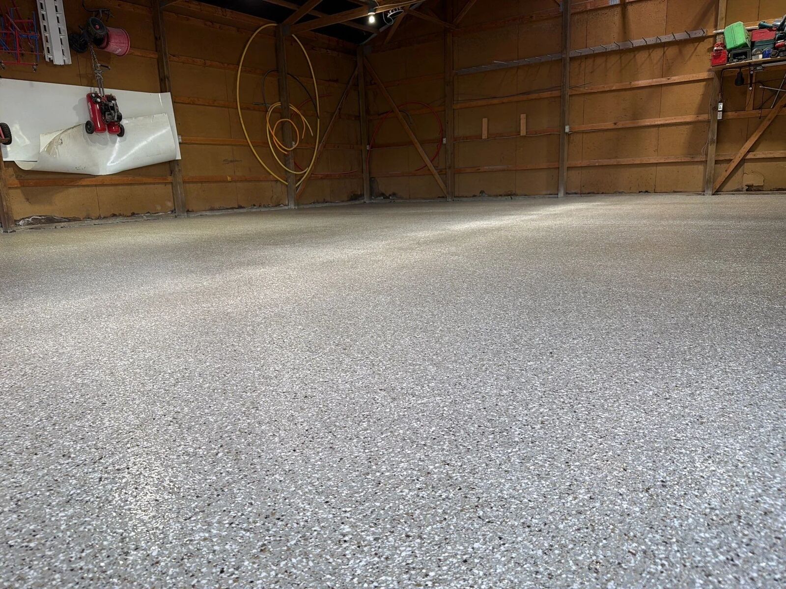 Finished light gray flake floor in a long room with windows