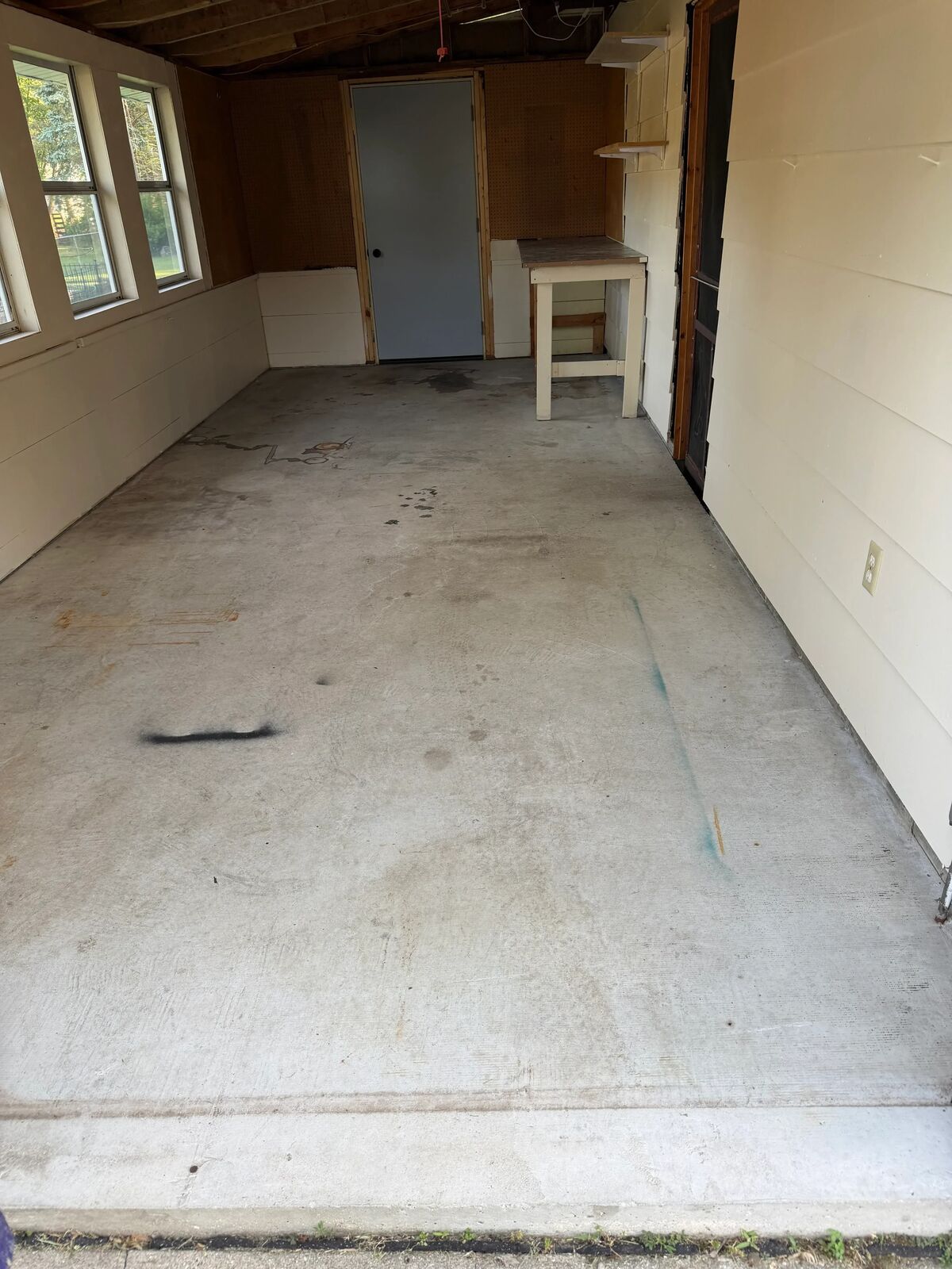 Uncoated concrete floor in a garage before grinding