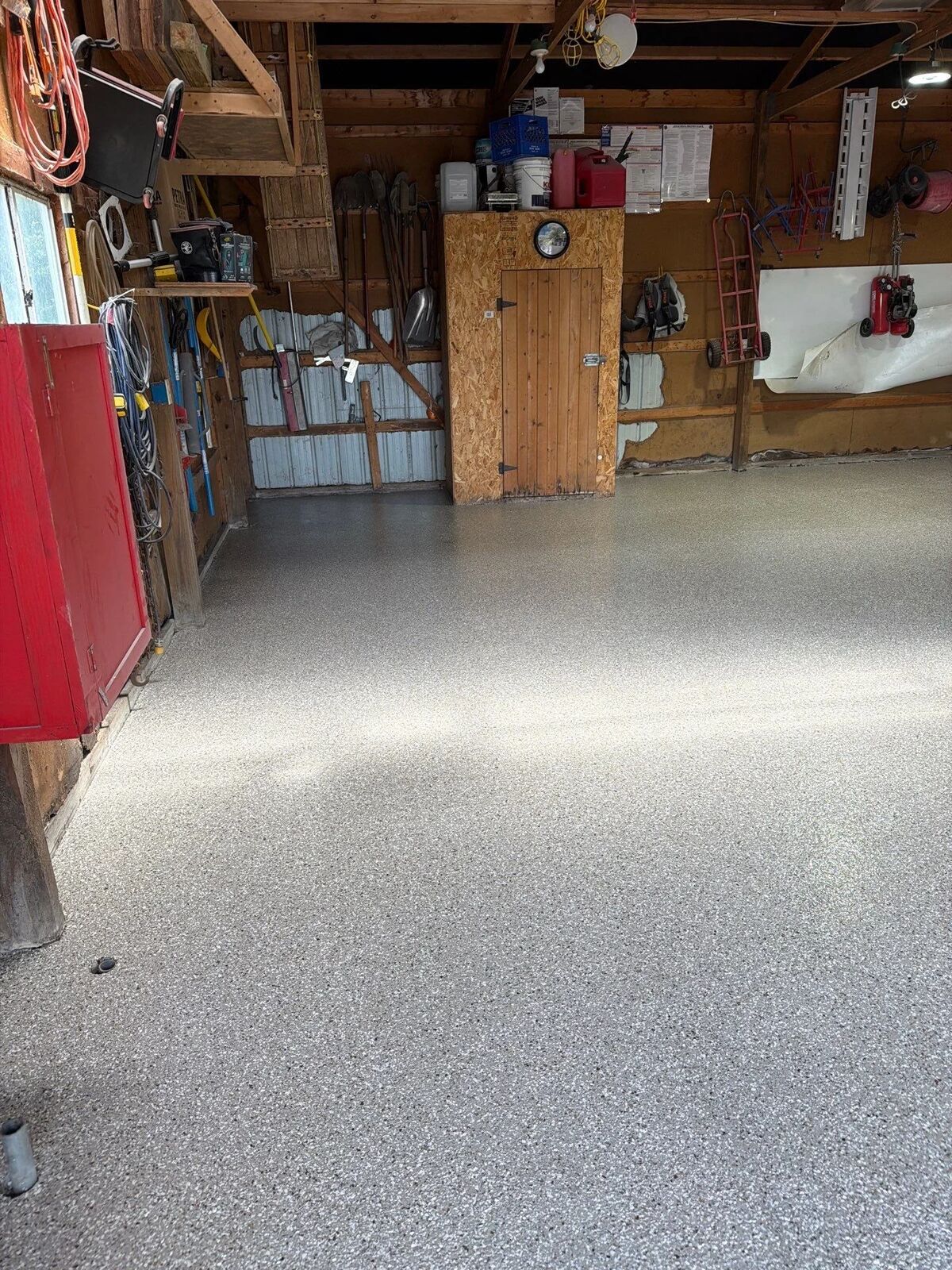 Flake-coated concrete walkway along a house under a covered porch