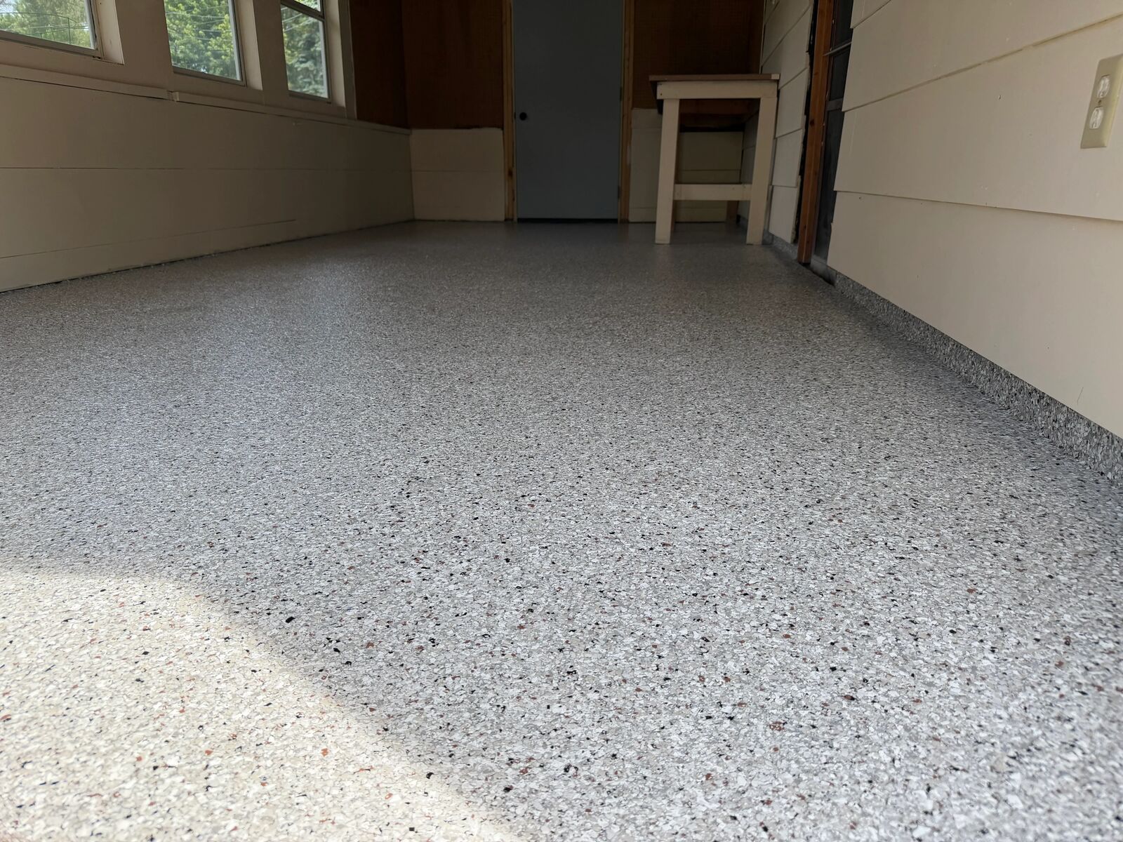 Wide finished flake floor across a wood-framed garage